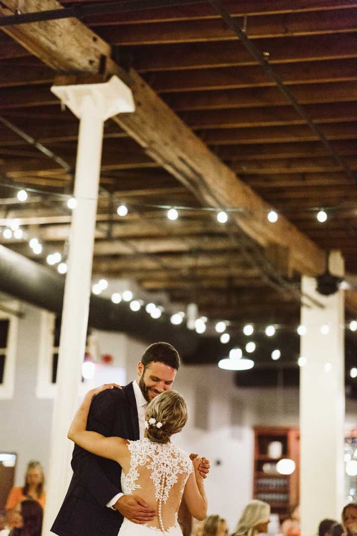 A couples first dance after giving their wedding vows in a historic event center in MN